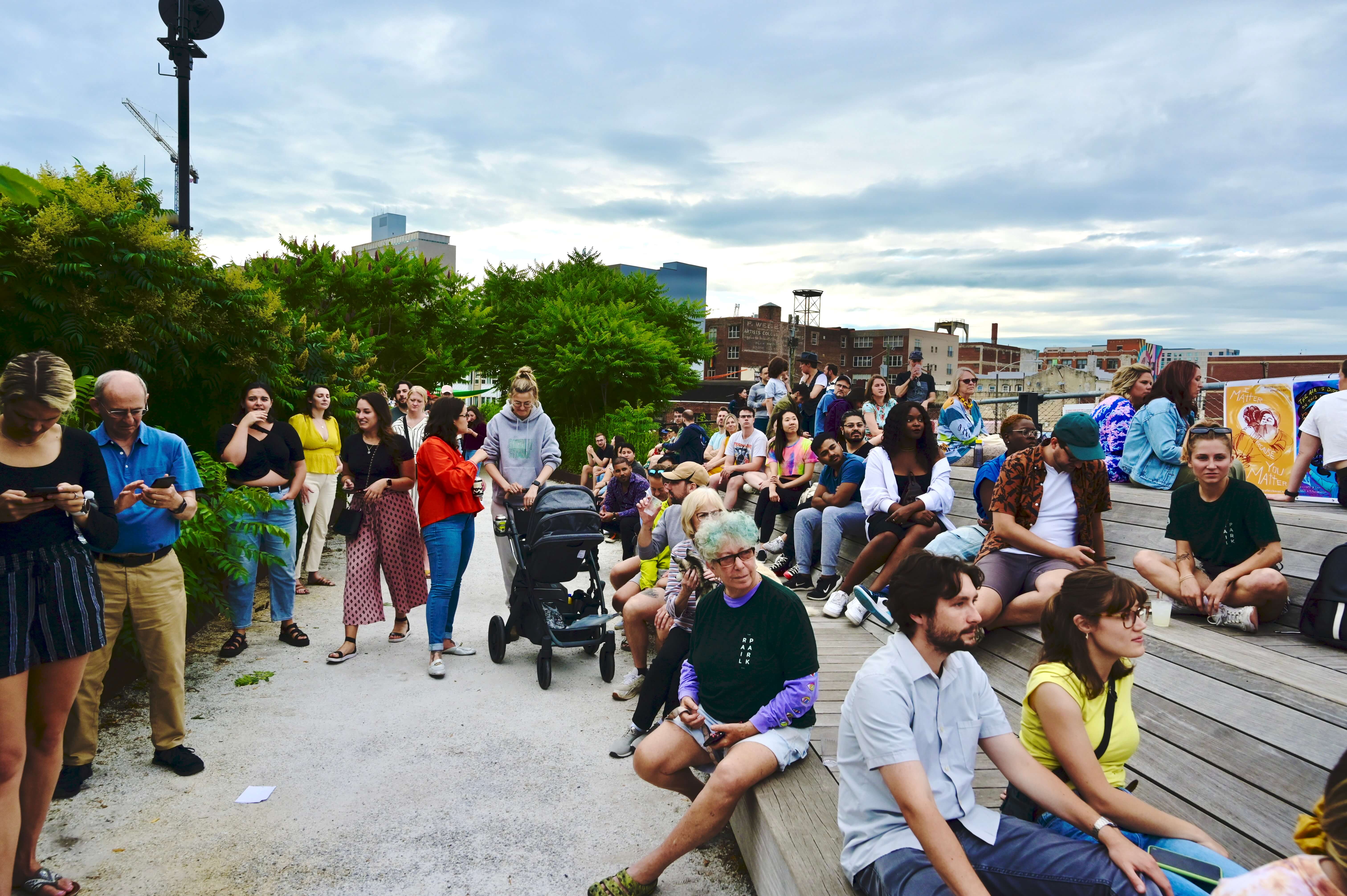 People sit on the platform benches at the Rail Park