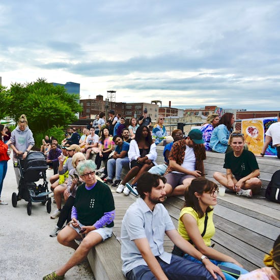 People sit on the platform benches at the Rail Park