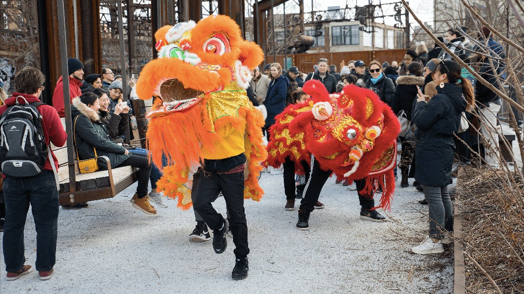 Lion Dancers perform in front of a crowd at the Rail Park
