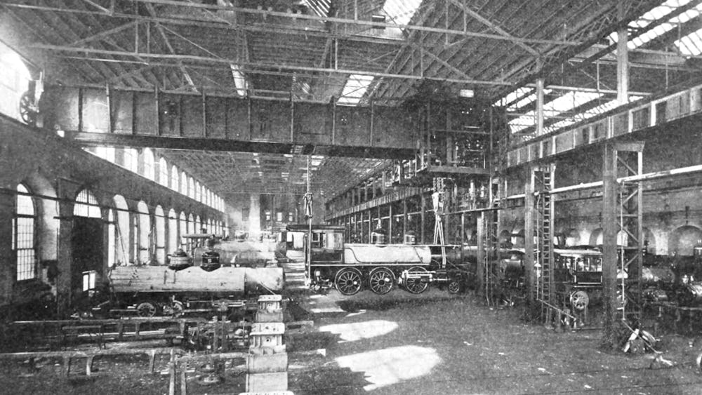 Black and white image showing the inside of a Baldwin Locomotives factory train shed