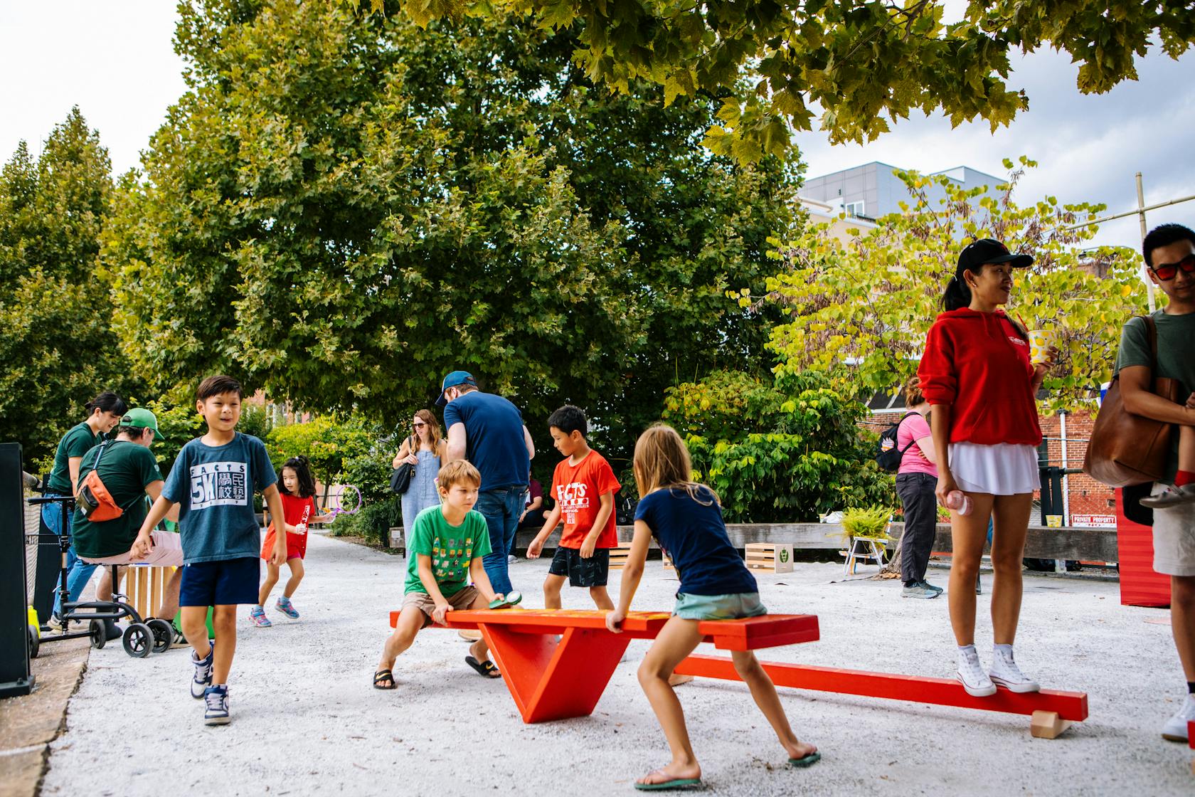 A group of children play on a see-saw
