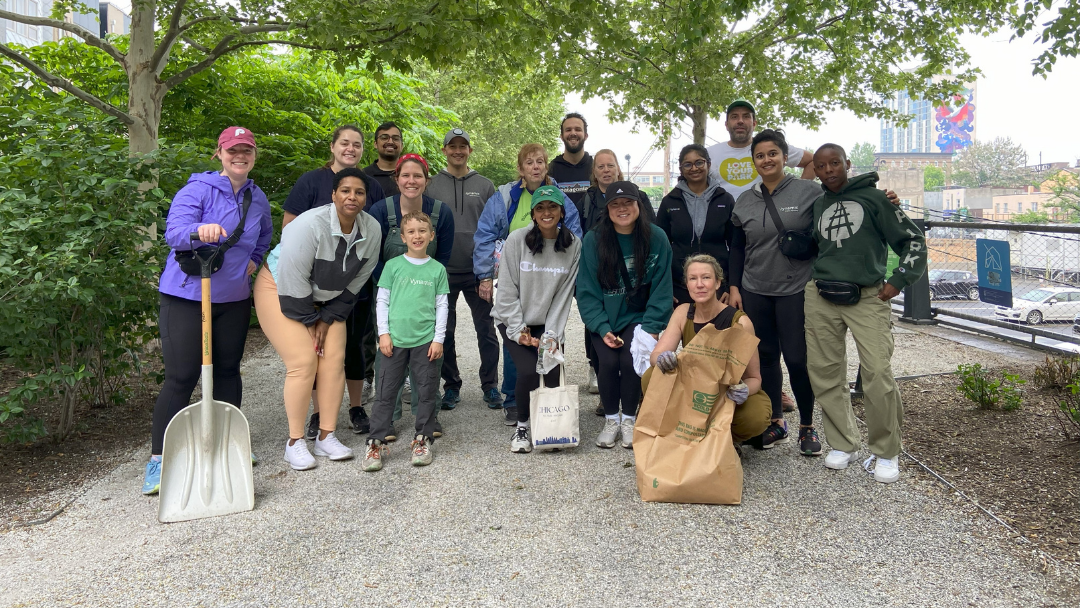 A large group of people posing after cleaning up the Rail Park.