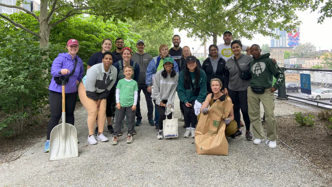 A large group of people posing after cleaning up the Rail Park.
