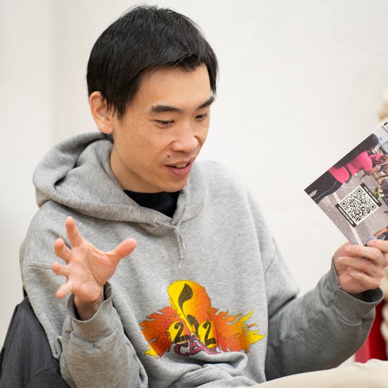 Community member talking during a meeting and gesturing with their hands