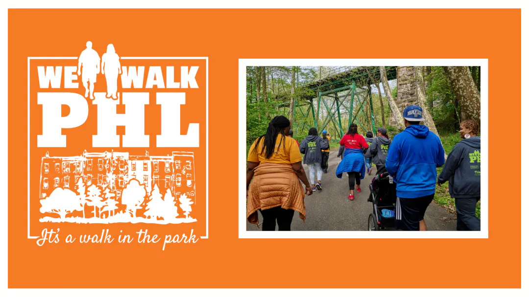 We Walk PHL logo with an illustration of two people walking in front of rowhomes and trees. Cursive writing underneath declaring "It's a walk in the park". To the right of the logo is a picture of the back of a We Walk PHL group on a trail with a bridge overhead.