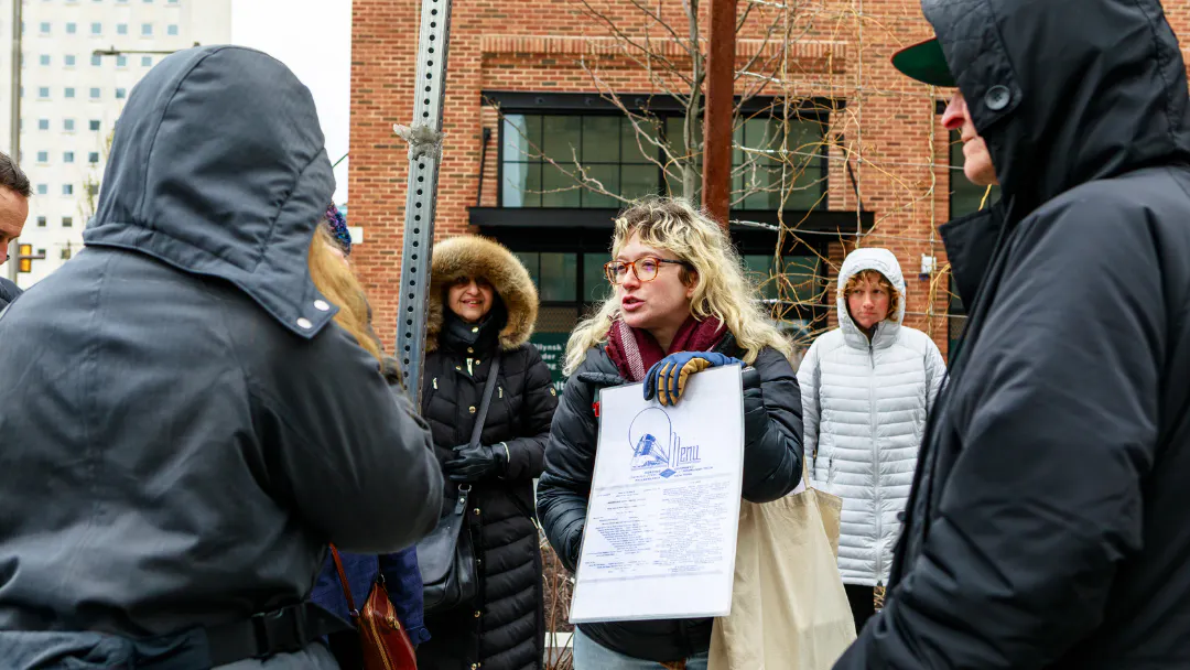 Tour Guide holds a menu from the diner that used to be housed in the abandoned Rail Car near the park.