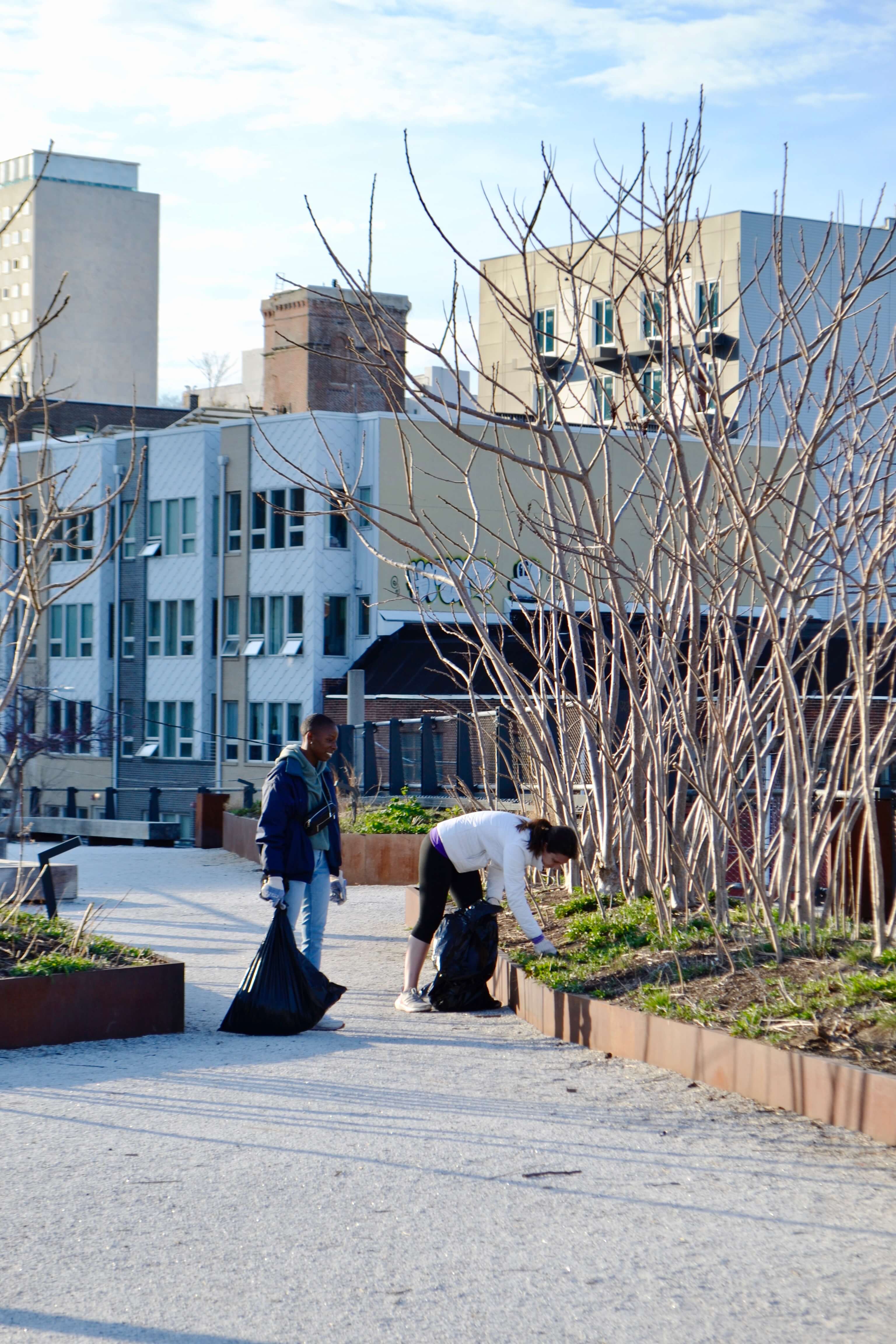 Volunteers pull weeds from planters