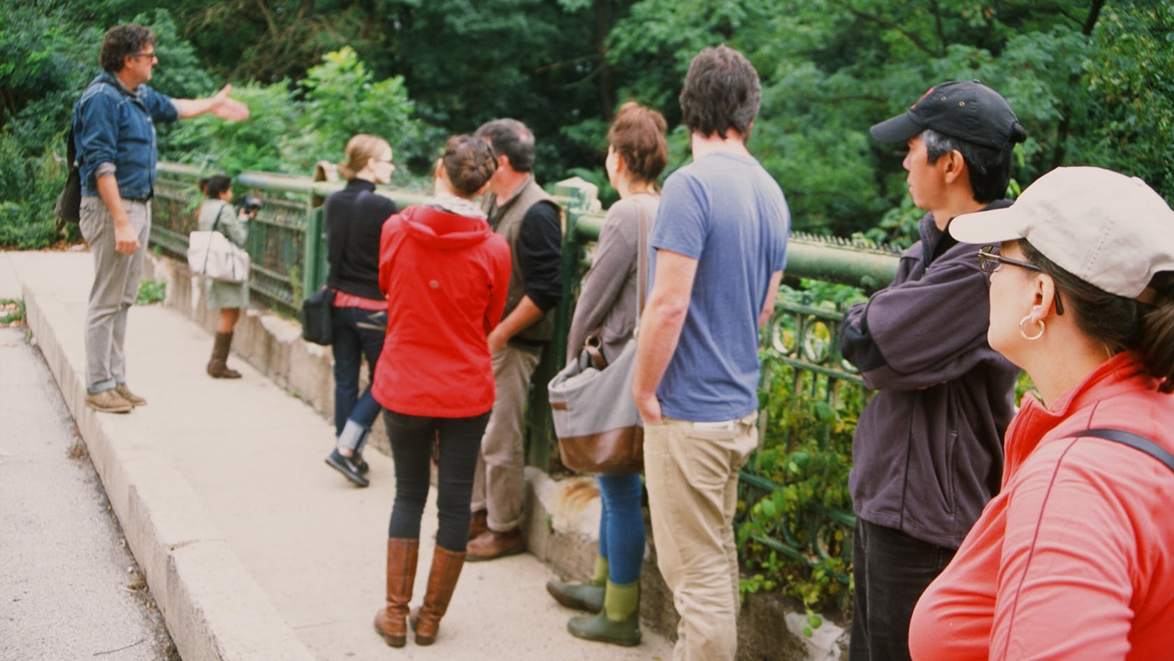 A group of people on a tour look out over the bridge down at the Tunnel