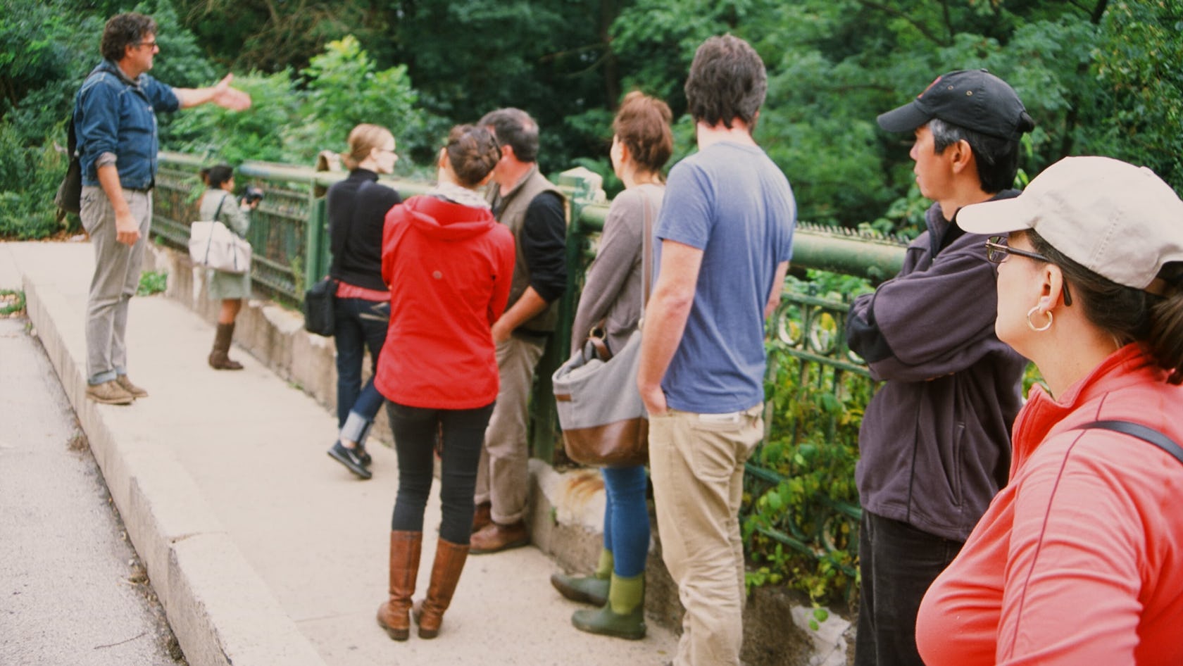 A group of people on a tour look out over the bridge down at the Tunnel