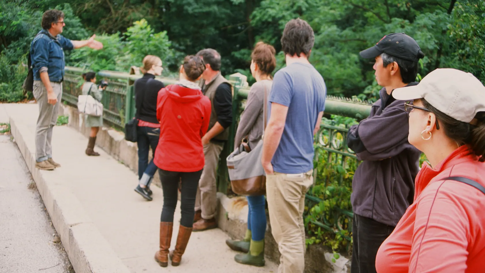 A group of people on a tour look out over the bridge down at the Tunnel