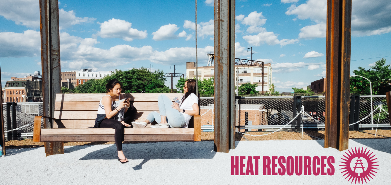 Two people relax on a wooden bench at the Rail Park on a sunny day beneath a blue sky, with the title "Heat Resources" and the Friends of the Rail Park logo displayed at the bottom.