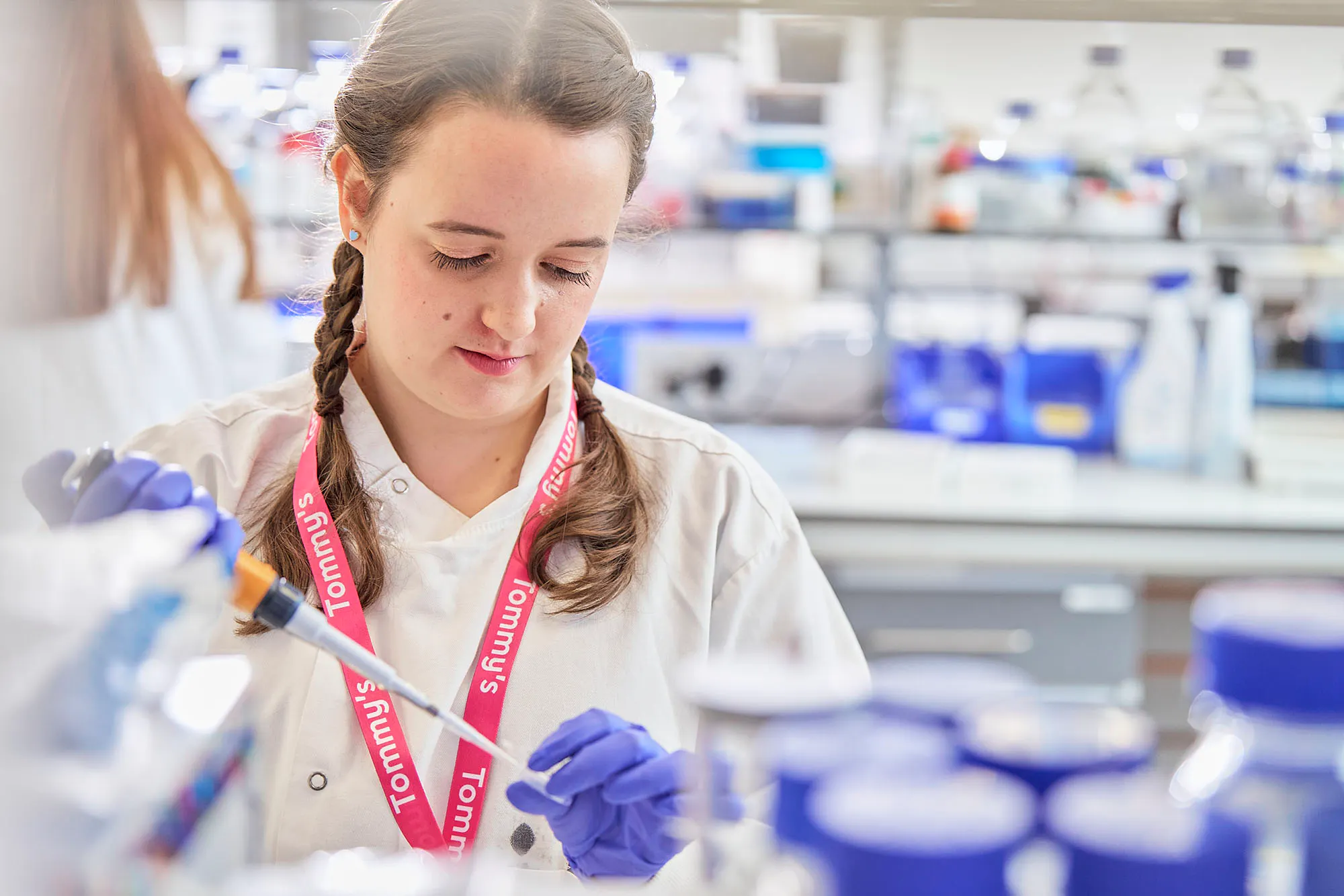 Photo image displayed shows a Tommy’s researcher in a laboratory at work.
