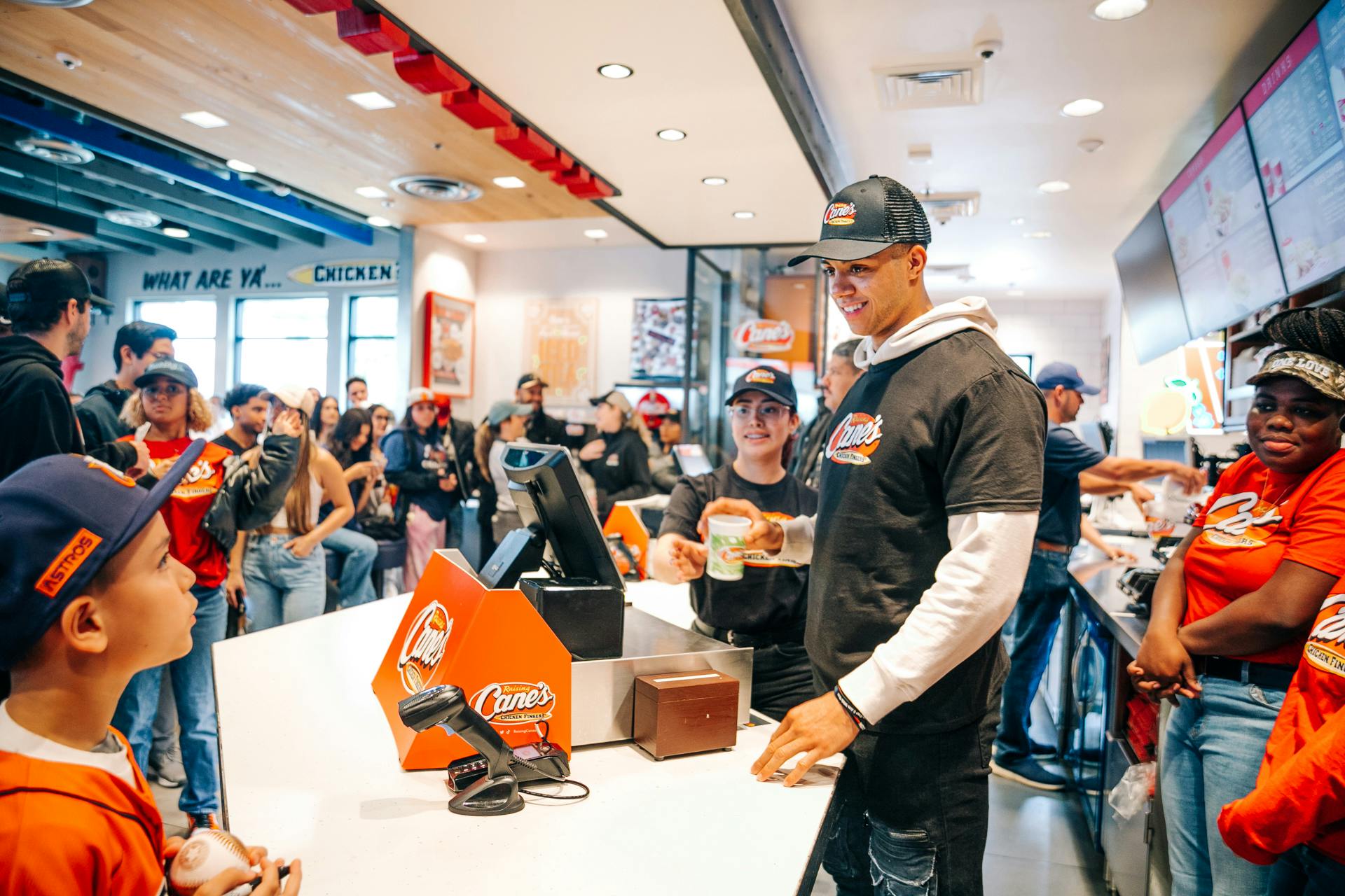 Jeremy Pena working the cash register at Raising Cane's