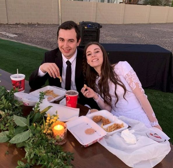 Couple enjoying Raising Cane's at their wedding.