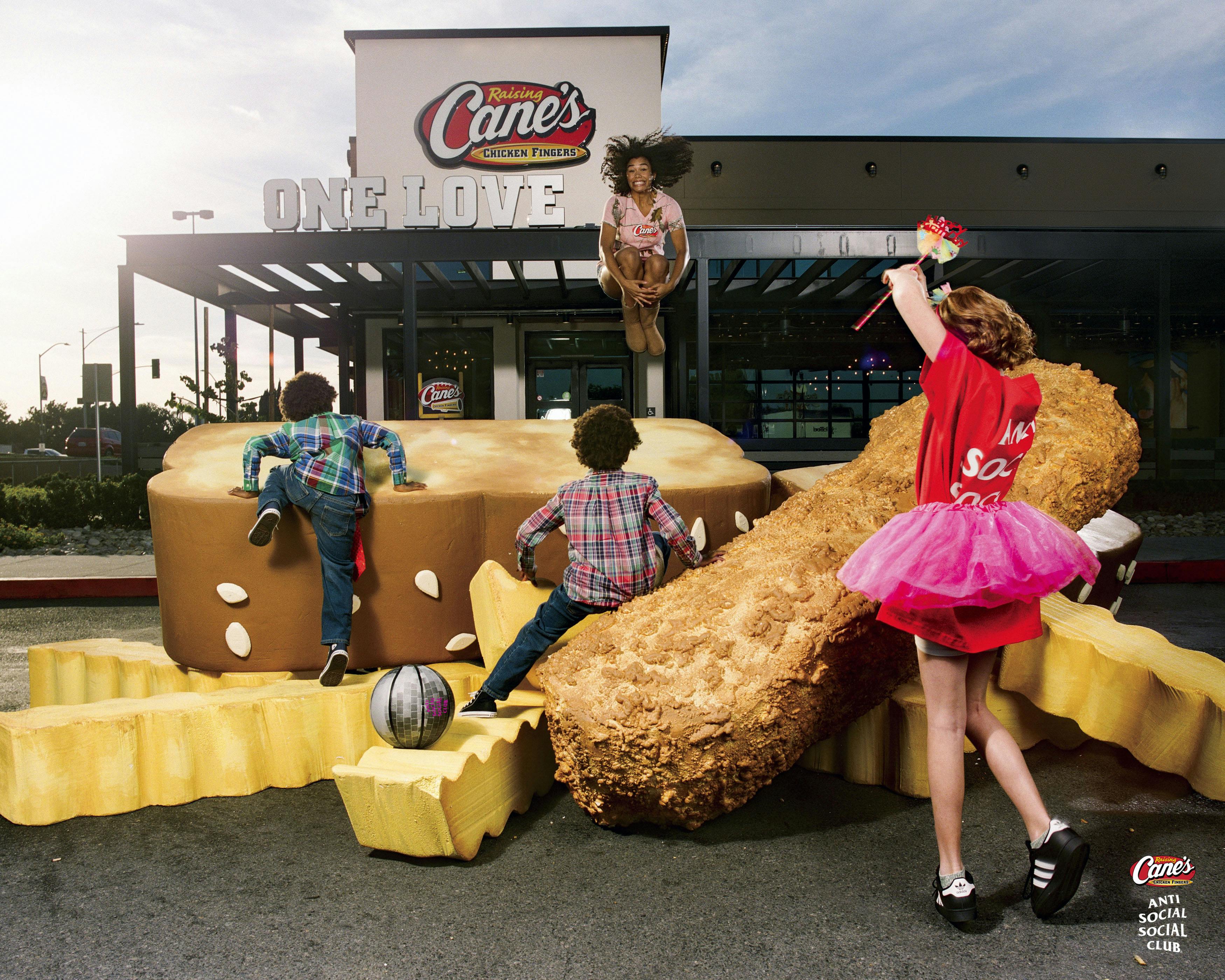 Raising Cane's and Anti Social Social Club merchandise on a larger than life size Chicken Finger, Toast and Crinkle Cut Fries.