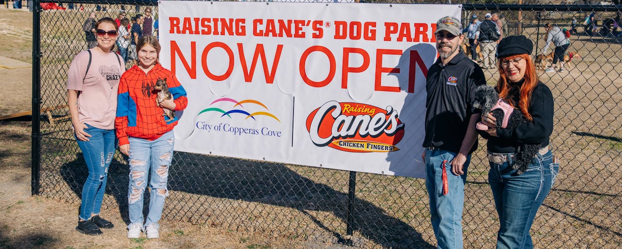 Owners and dogs at Raising Cane's dog park