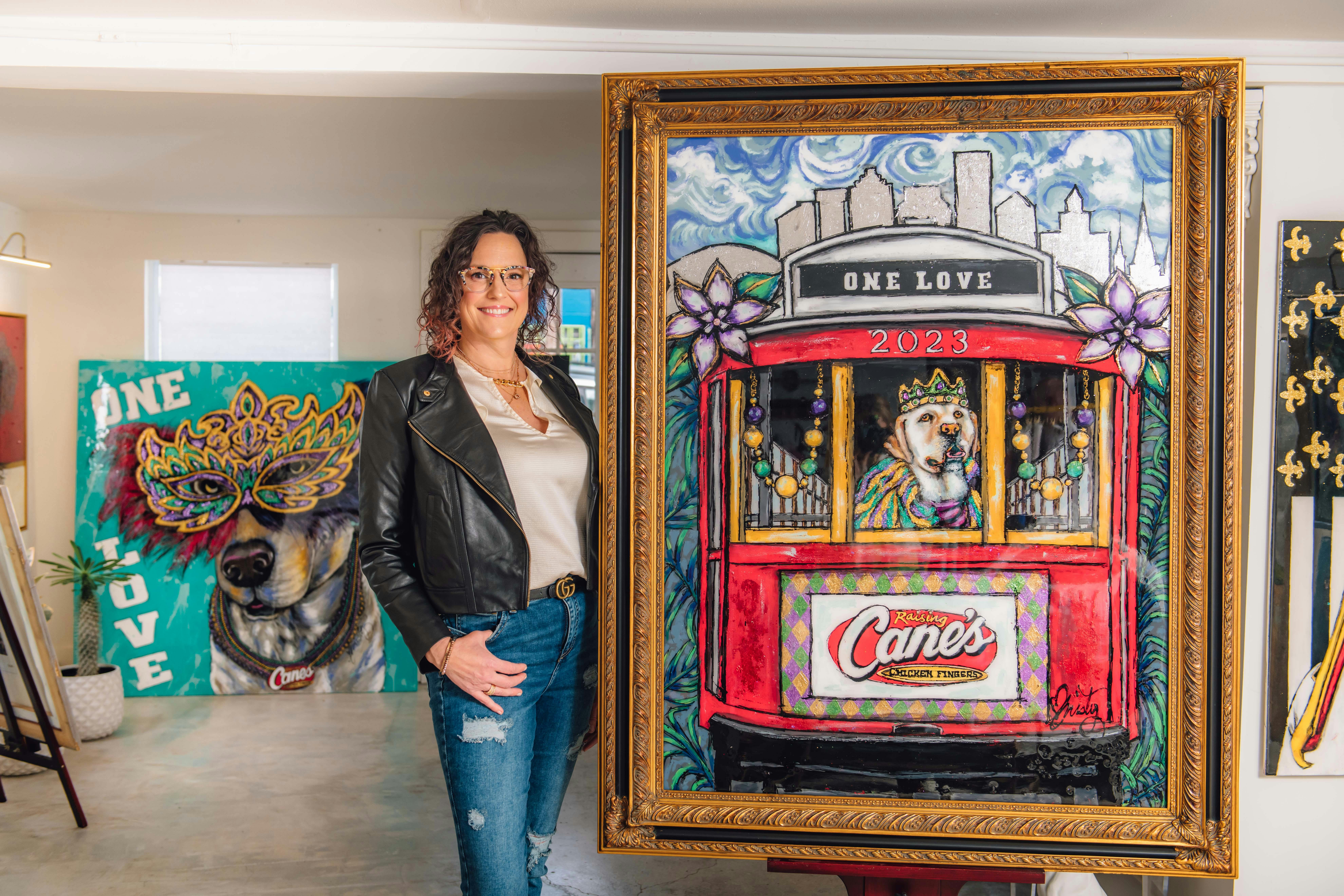 Artist Christy Boutte standing with her painting of Raising Cane 3 in a trolley