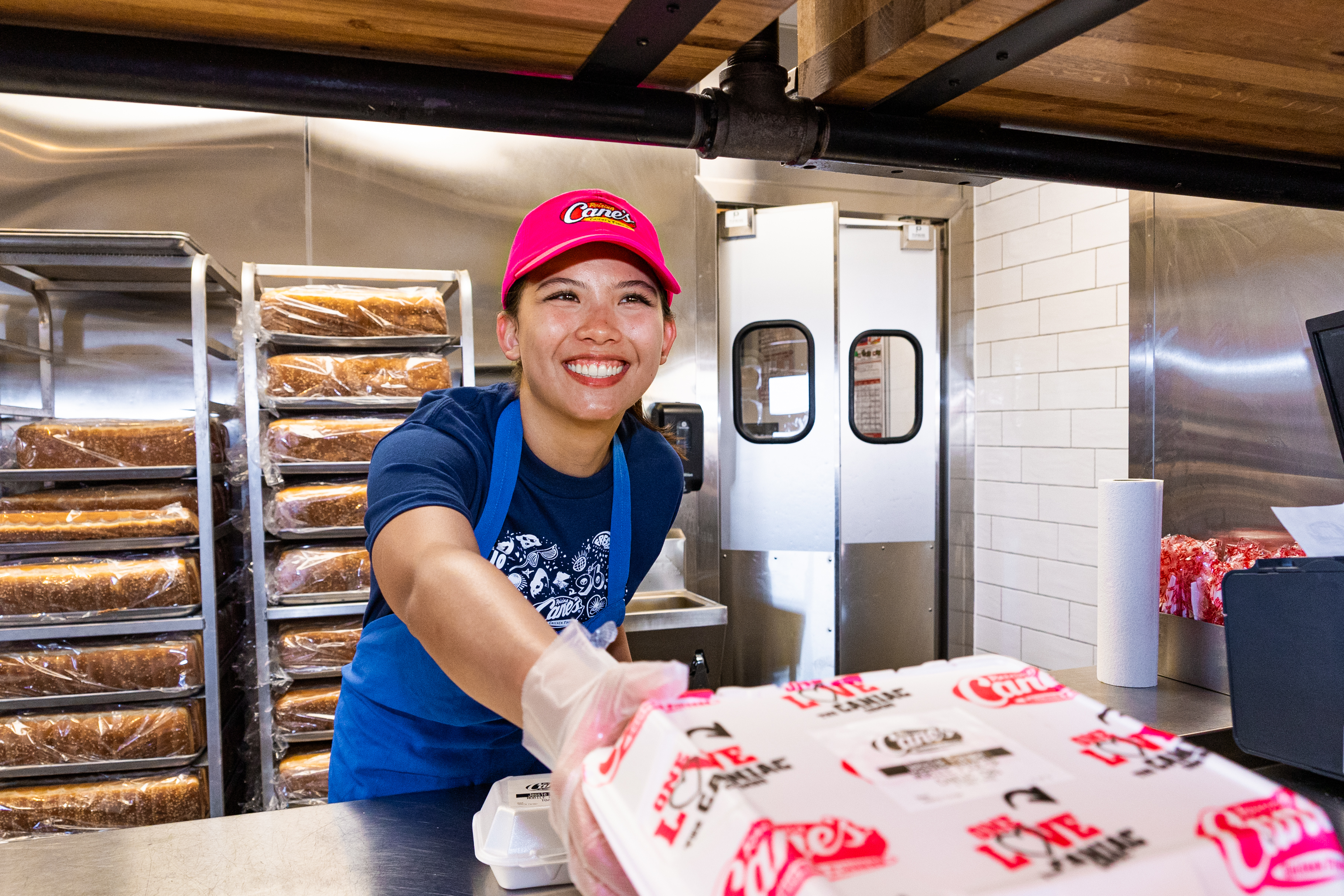 Crewmember serving up Chicken Finger meal