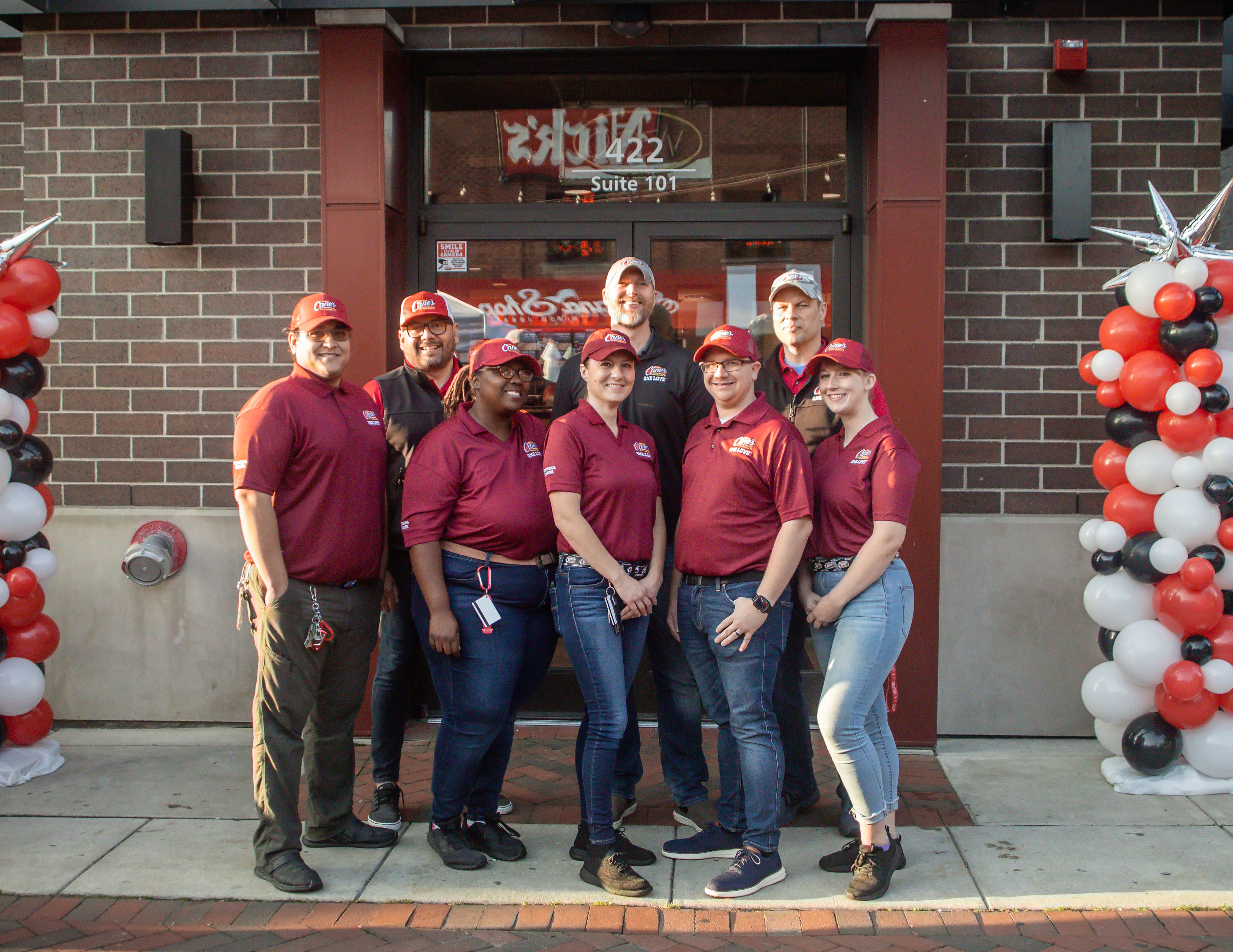 Raising Cane's Crewmembers outside the Restaurant