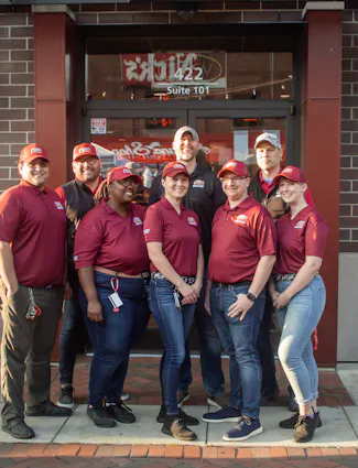 Raising Cane's Crewmembers outside the Restaurant