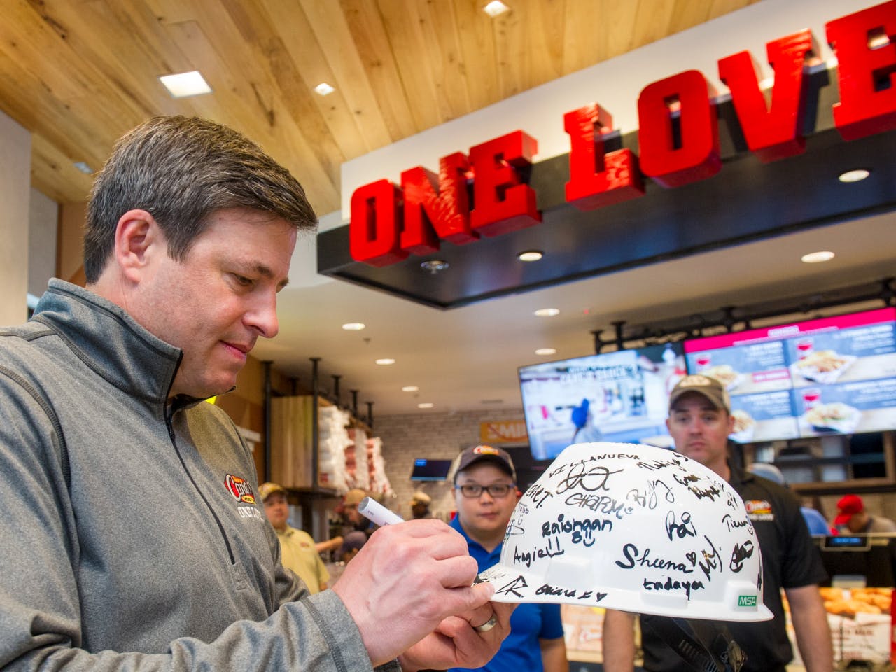 Todd Graves signing a hard hat