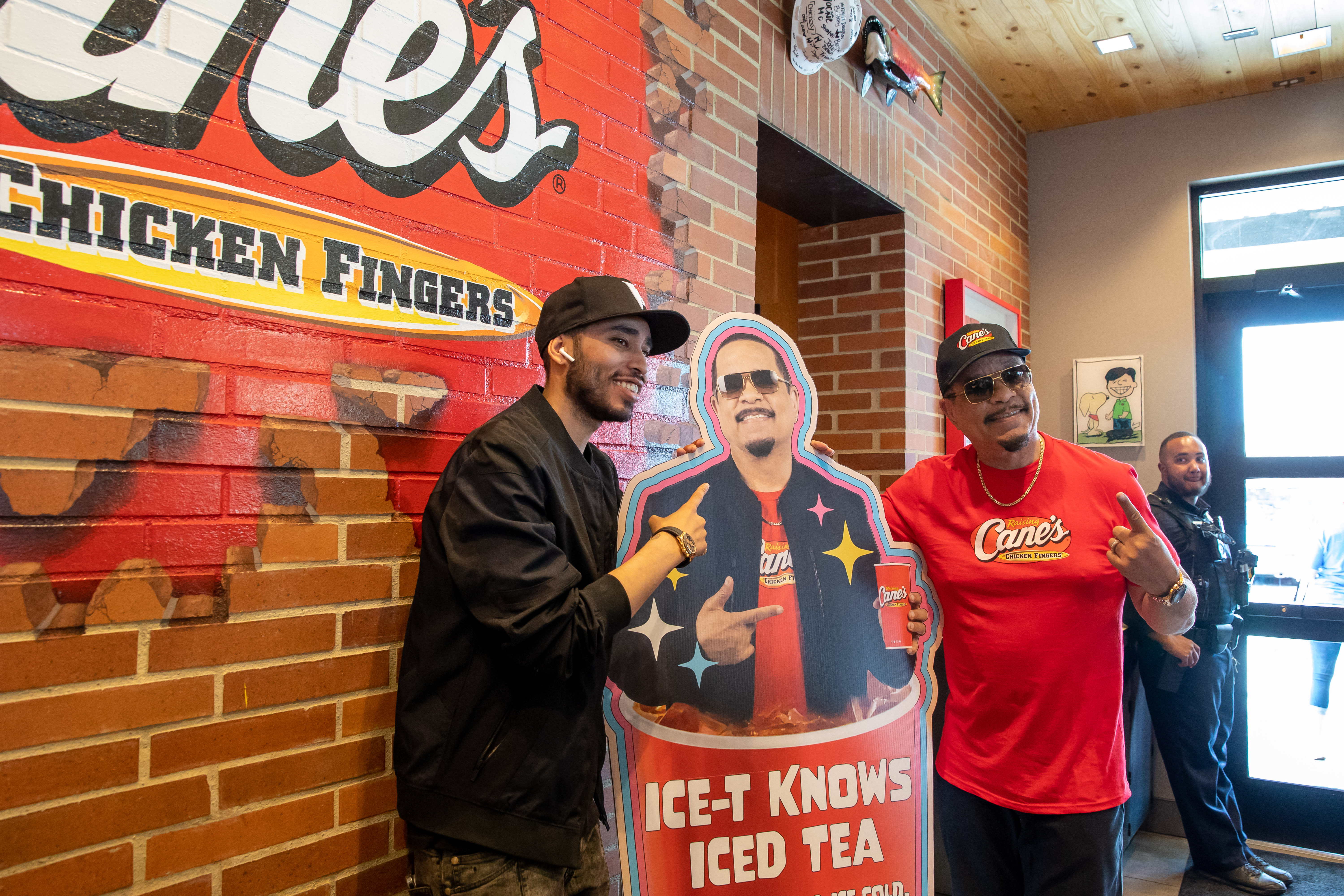 Rapper, Ice-T, posing with Ice-T standee.