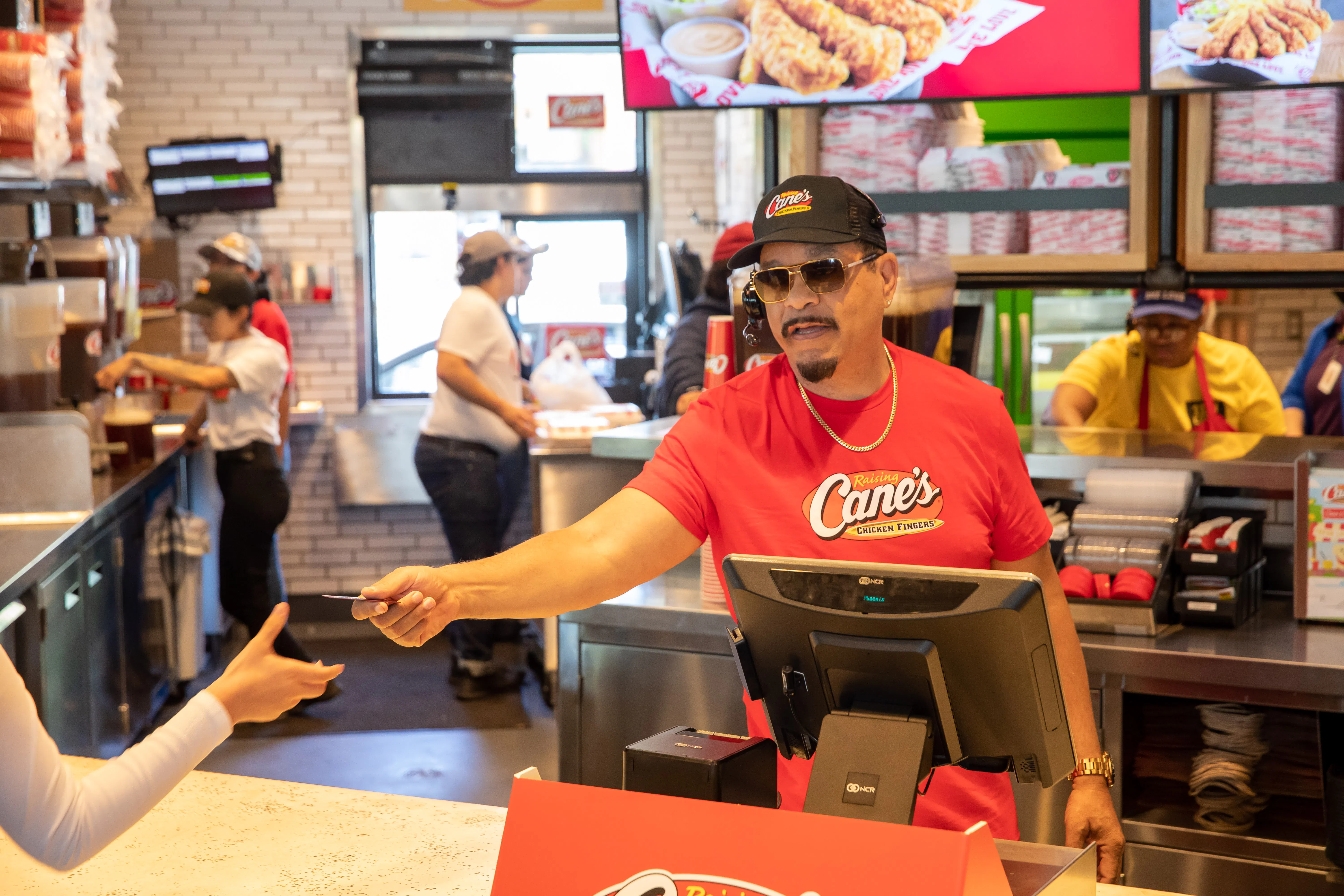 Rapper, Ice-T working the Raising Cane's front counter.