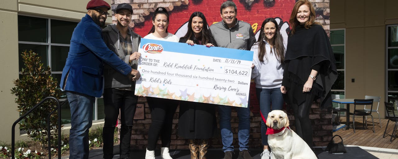 Todd Graves presenting a check to Kid Kraddick in the morning.