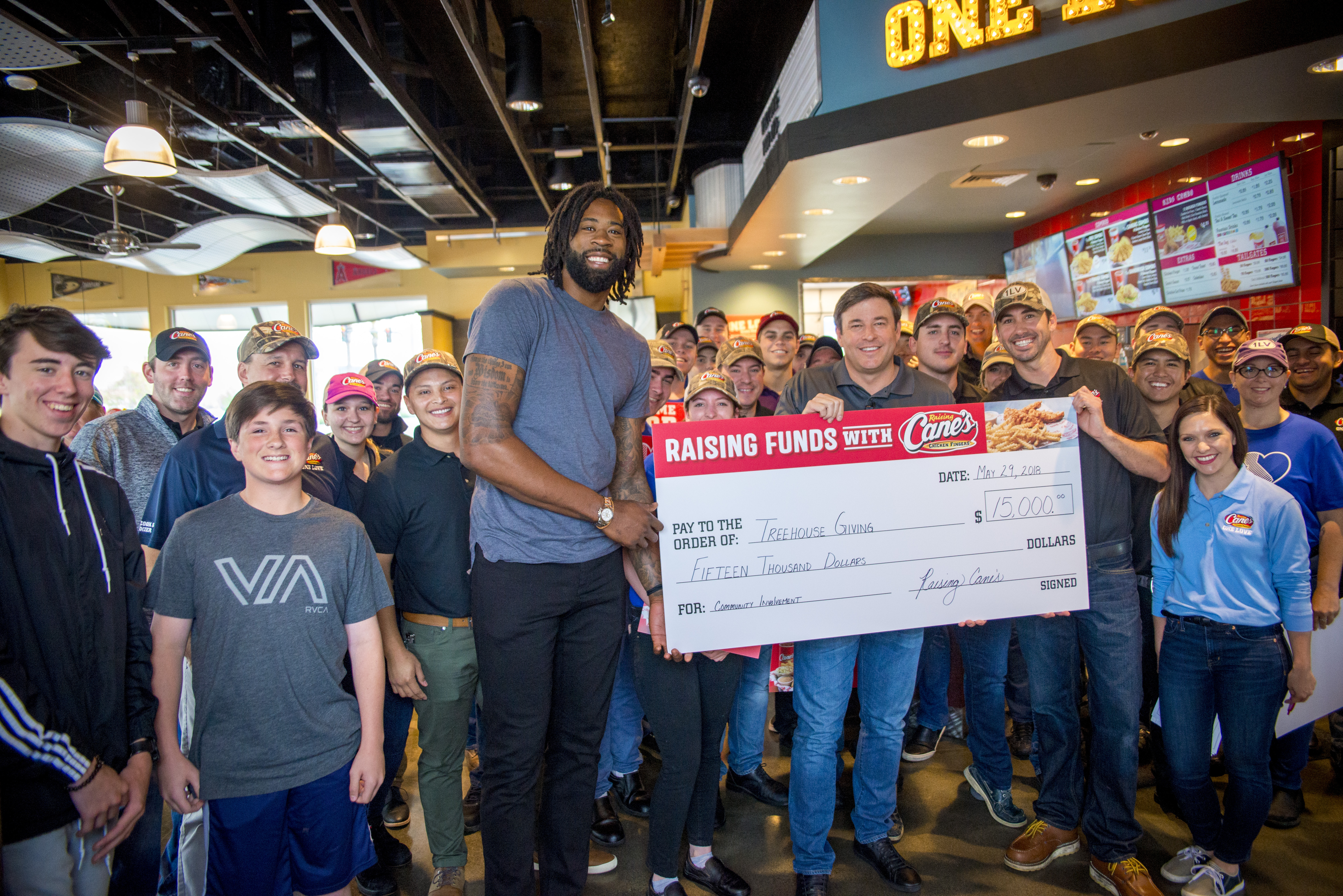 Raising Cane’s Founder Presents $15,000 Donation  To DeAndre Jordan’s Treehouse Giving Foundation