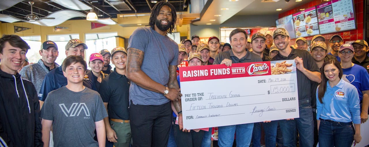 Raising Cane’s Founder Presents $15,000 Donation  To DeAndre Jordan’s Treehouse Giving Foundation