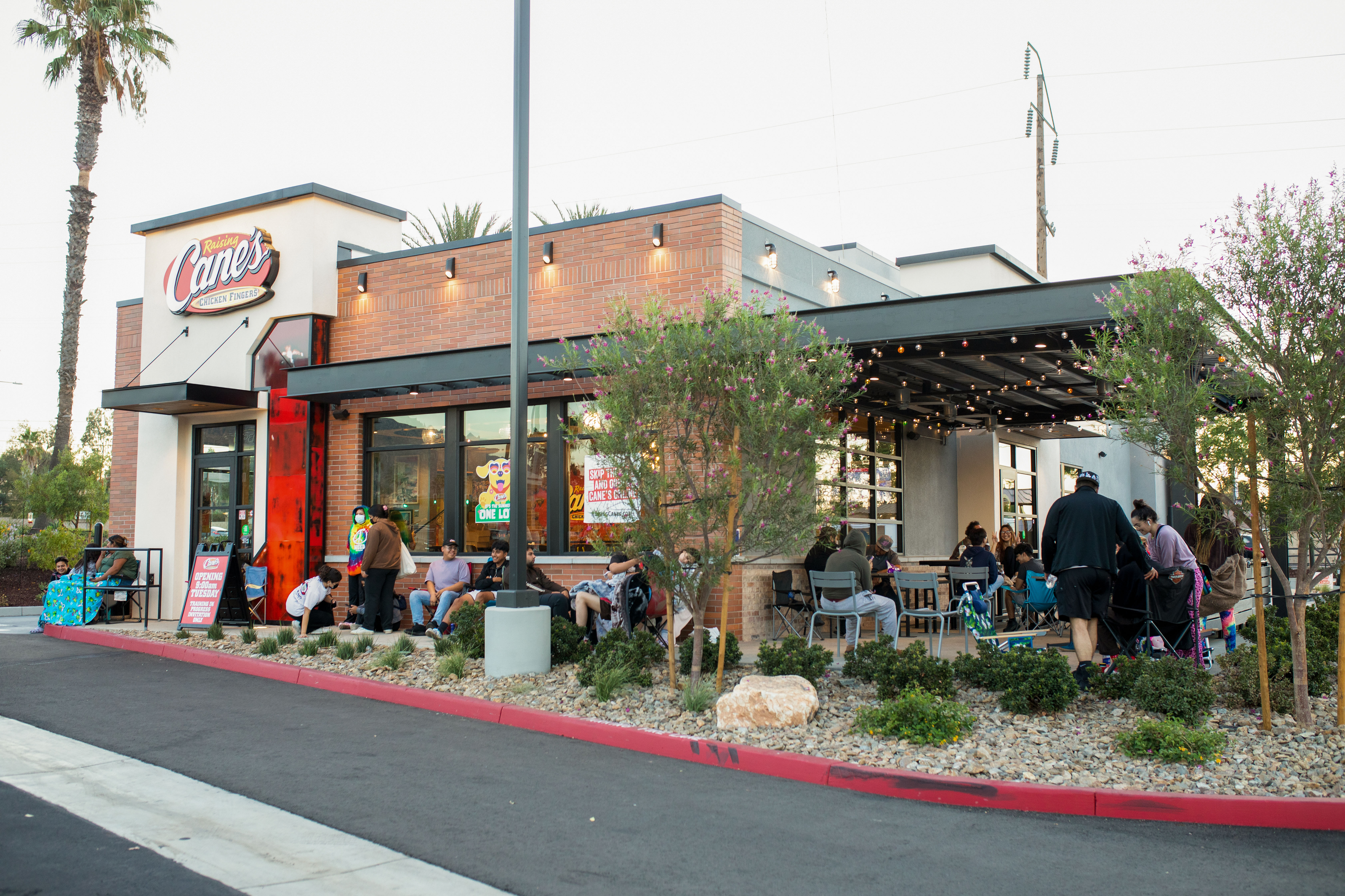 Customers dining outdoors at Raising Cane's