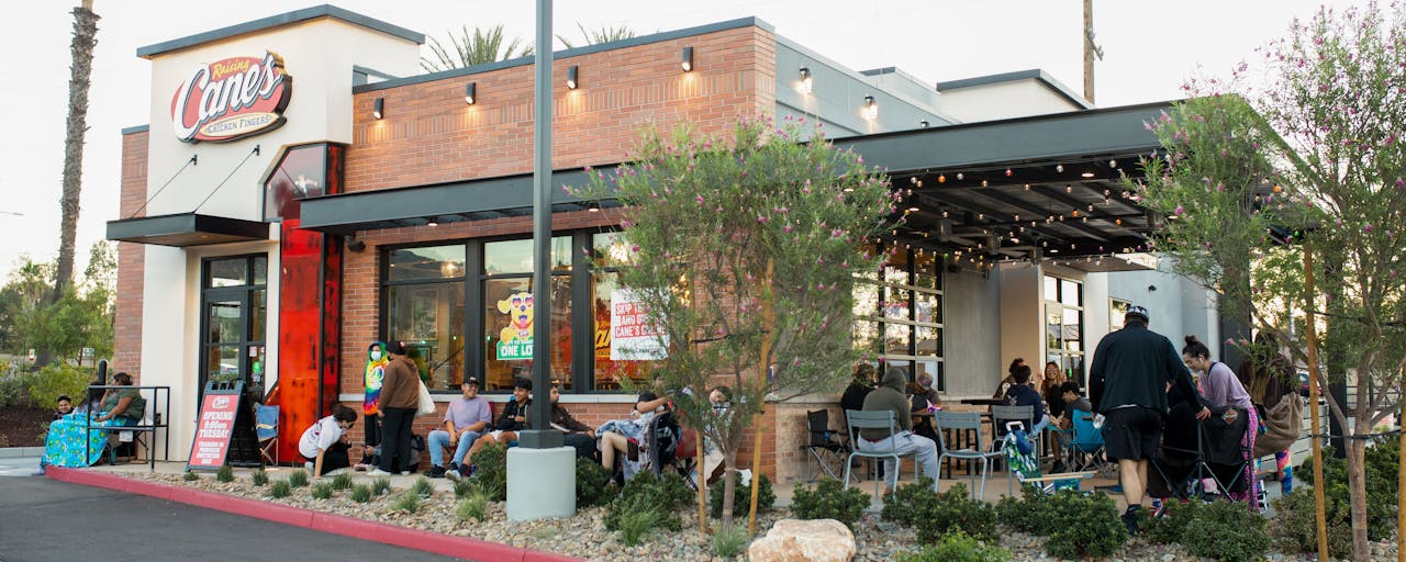 Customers dining outdoors at Raising Cane's