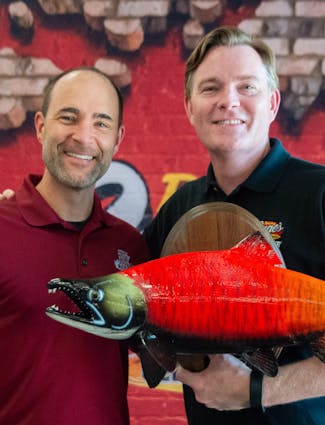 Two Crewmembers holding fish