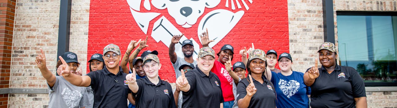 Raising Cane's Crew in front of Restaurant