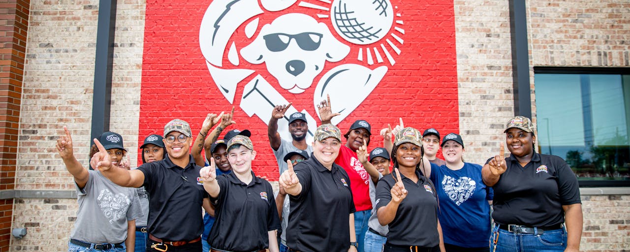Raising Cane's Crew in front of Restaurant