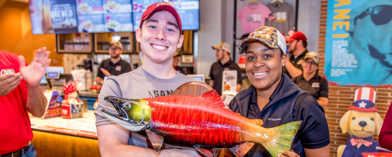 Two Crewmembers holding a big fish