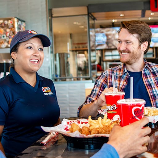Raising Cane's employee and customer in the dining room