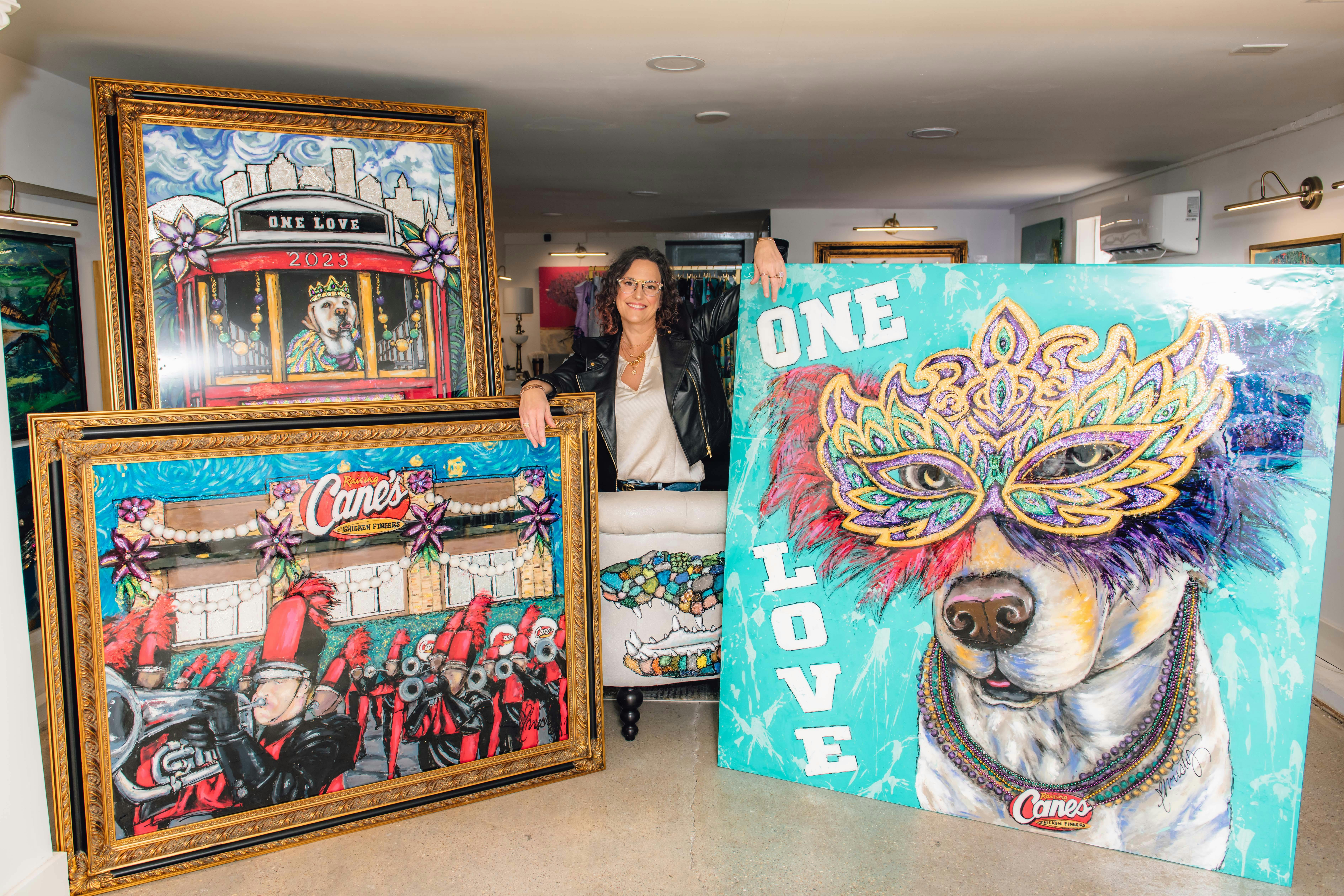 Artist Christy Boutte standing with her custom painting for Raising Cane's.