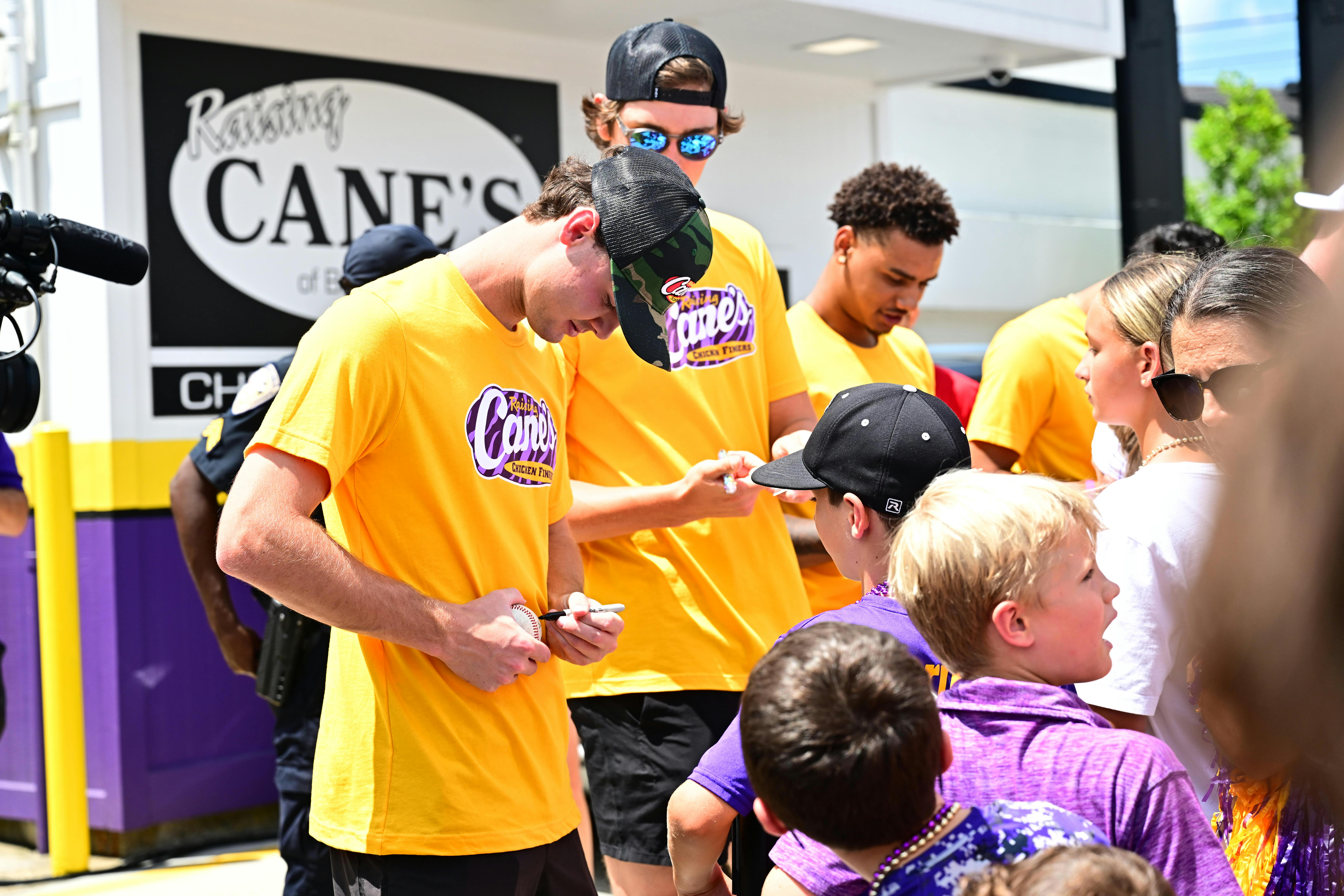Kade Anderson and team signing autographs