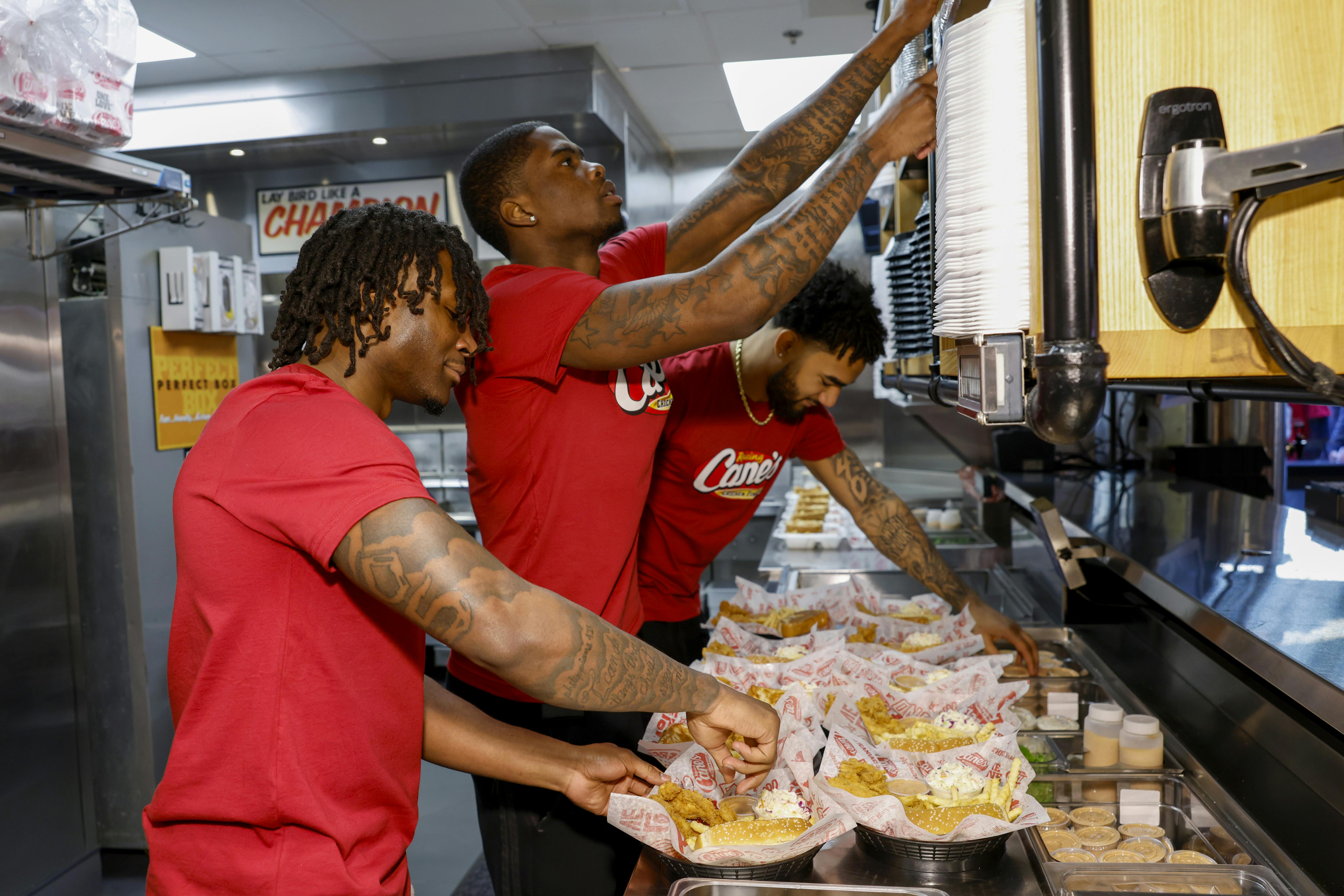 D'Angelo, Jamari, and Elijah serving up Raising Cane's Box Combos