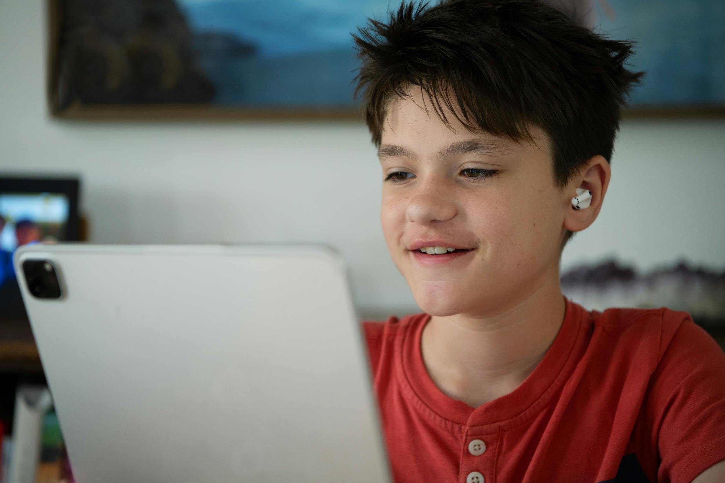 A boy is excited to read on his iPad