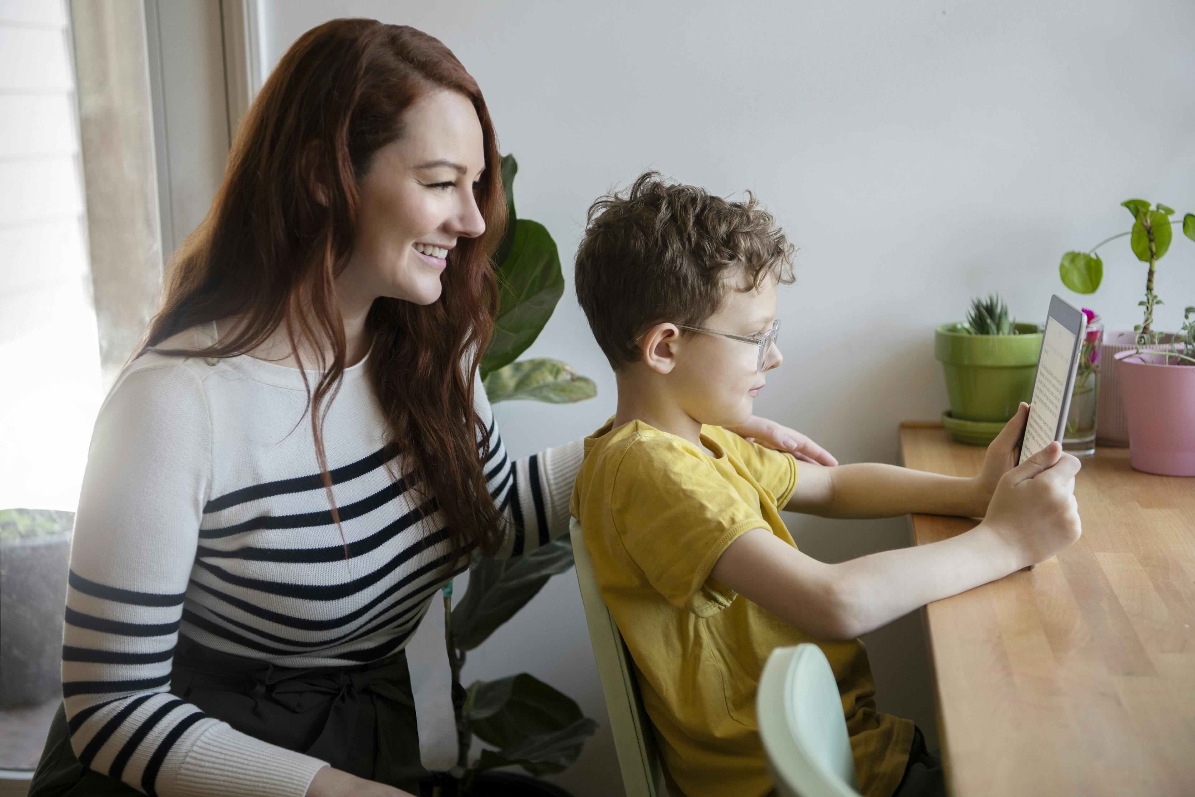 A parent and child are happily reading together