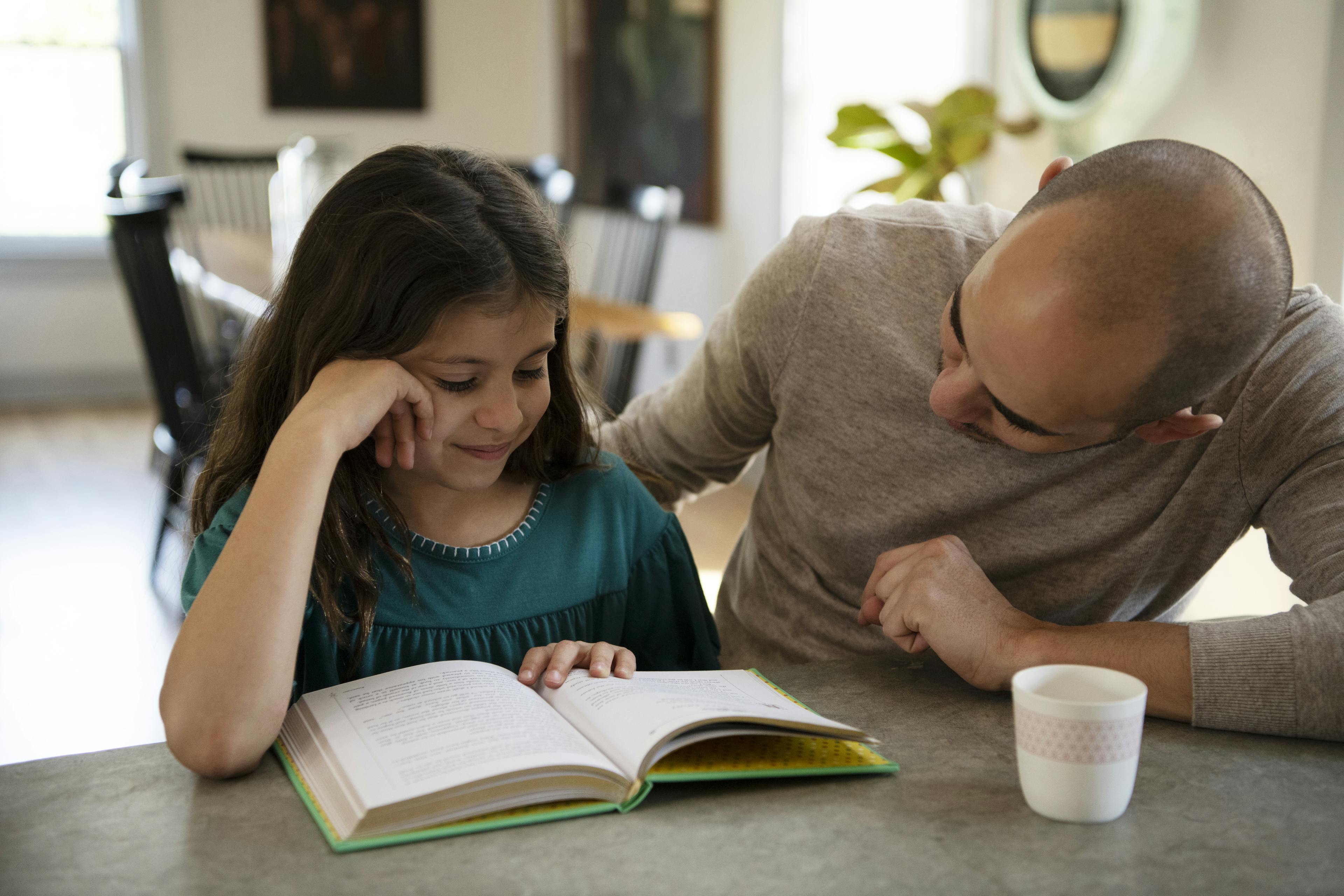 A parent and child read together