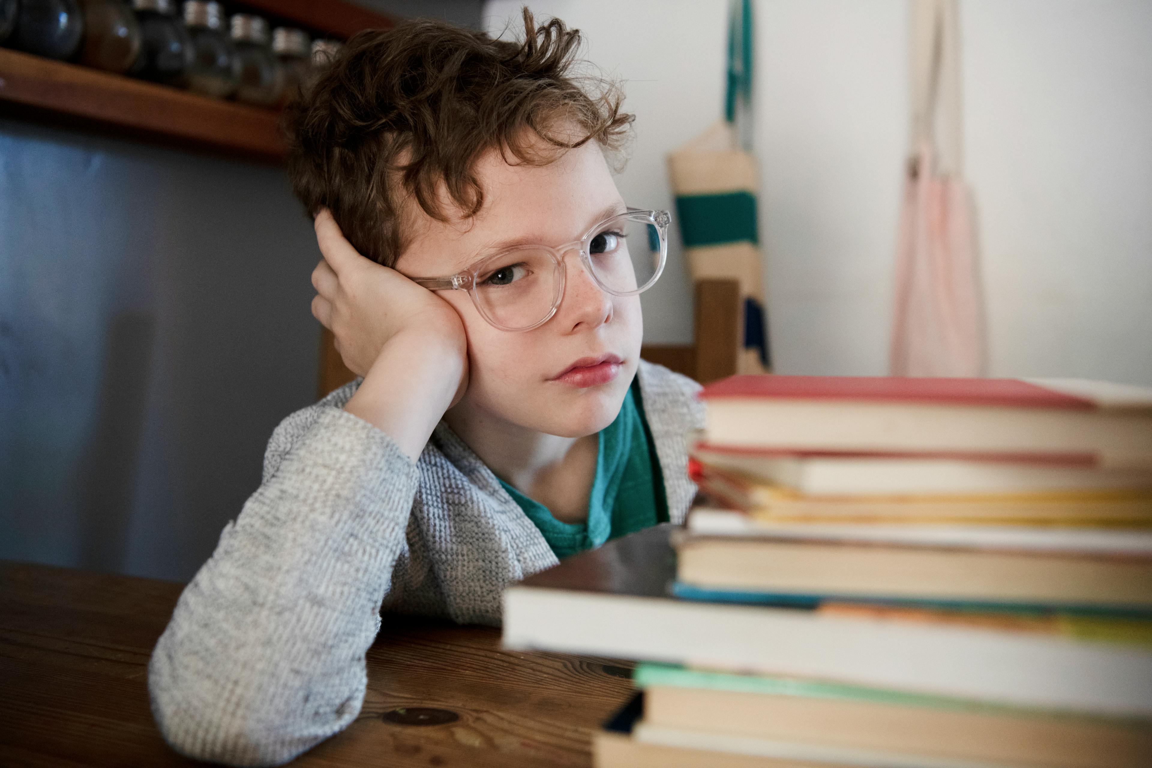 A child looks sad about having to read