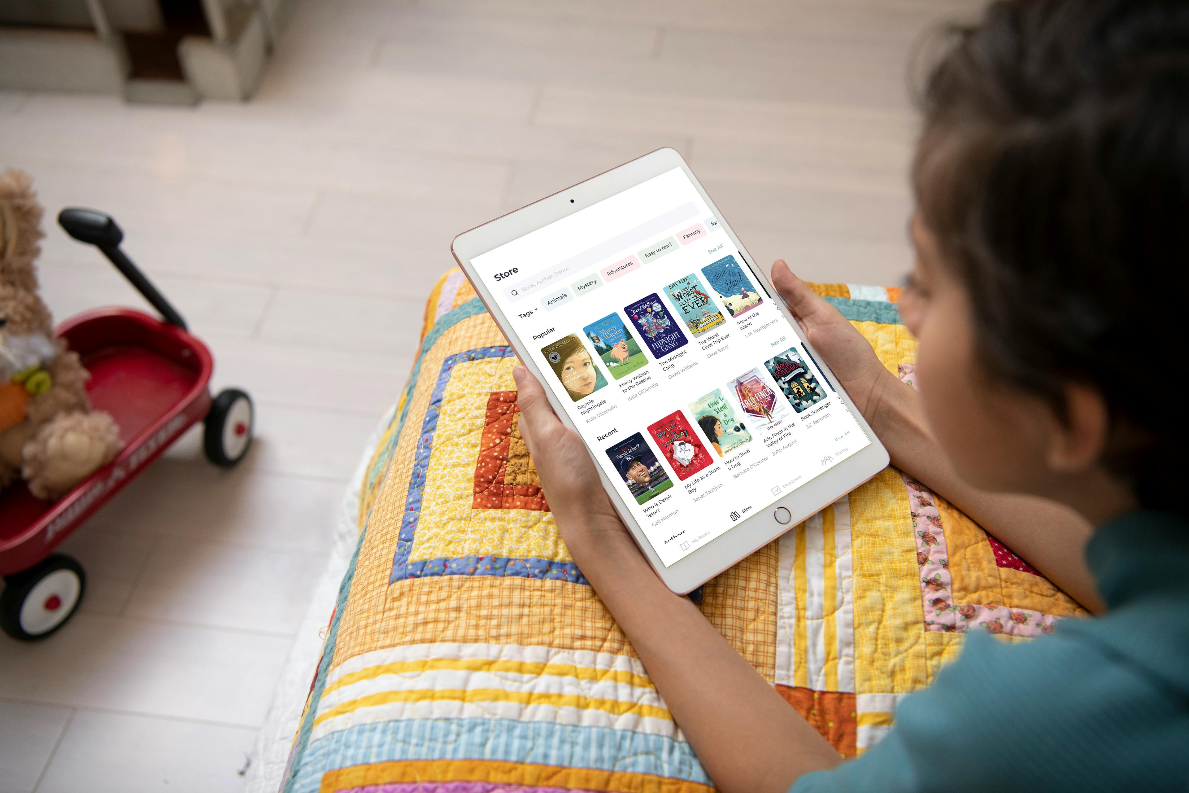 A child reads at home on their iPad