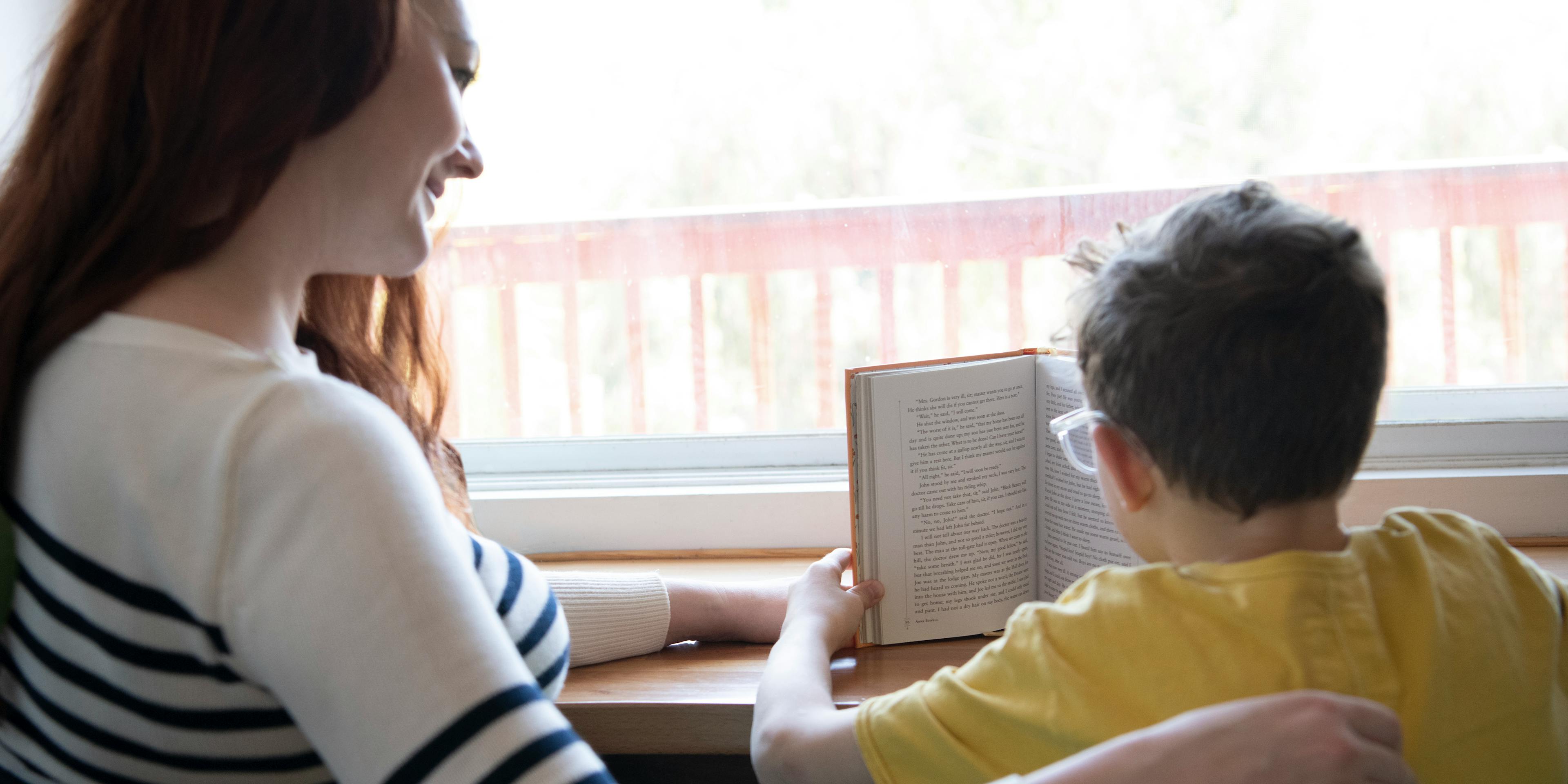 A parent and child read together