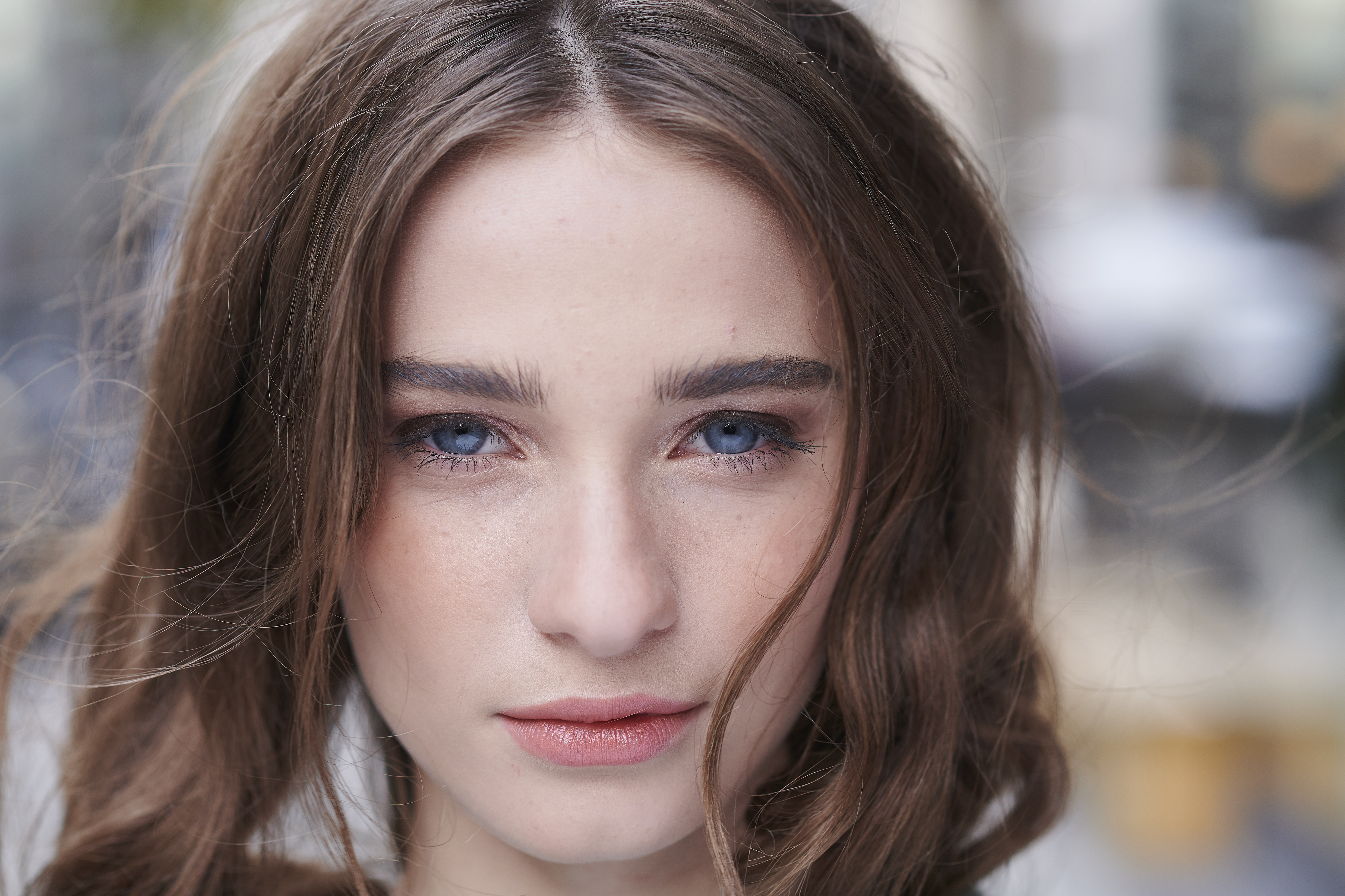 Close up of straight dark haired girl with blue eyes