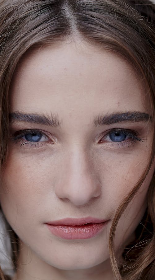 Close up of straight dark haired girl with blue eyes