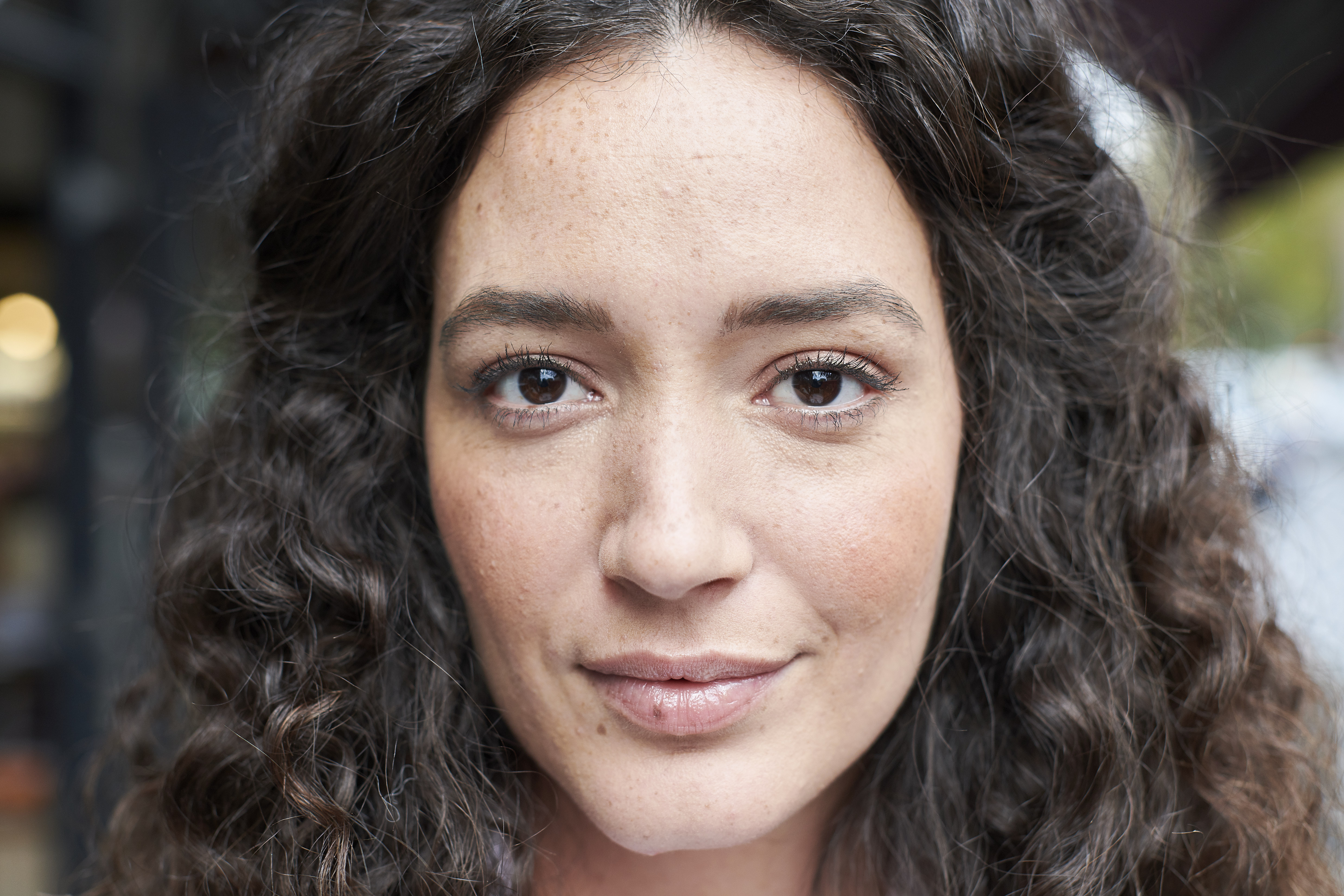 Close up of curly dark haired girl with brown eyes