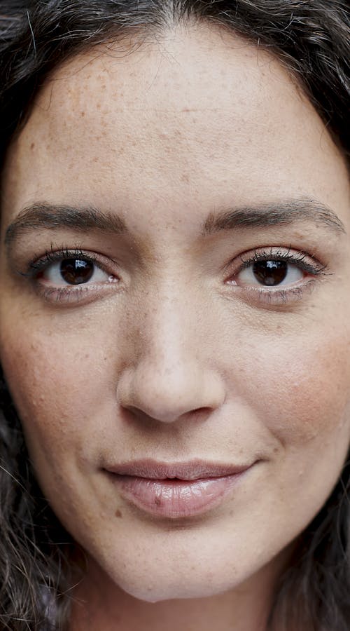 Close up of curly dark haired girl with brown eyes